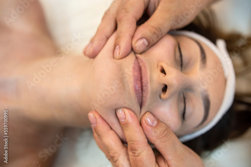girl client is lying down for a facial massage in the best spa salon in town.