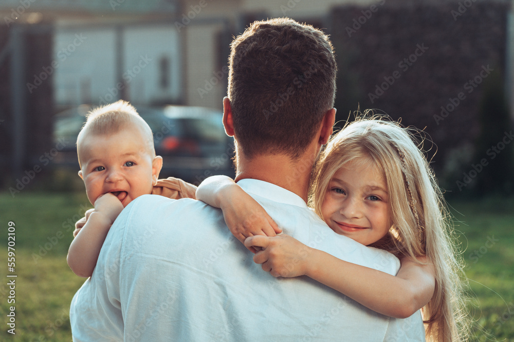 Fototapeta premium Father with happy and smiling children at summer