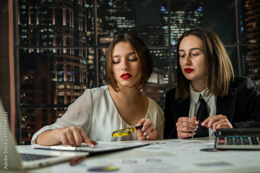 Fototapeta premium Two business woman working together with financial statistics documents