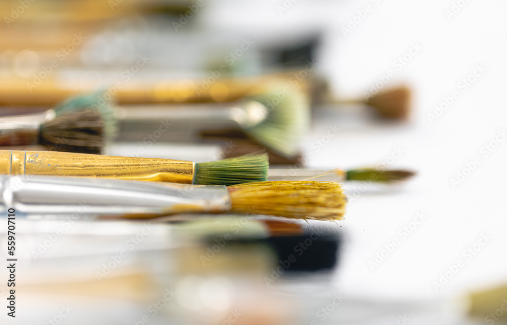 Paint brushes stained with paint, close-up, macro shot. Paint brushes stained with paint, close-up, macro shot.