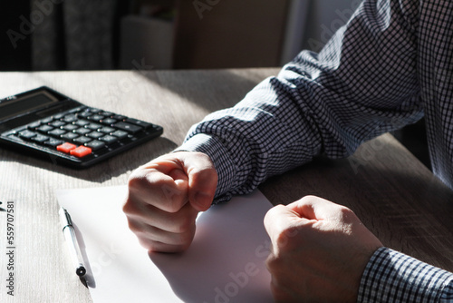 Businessman pounding fist on table, cropped image. Angry businessman showing his fists. Frustrated businessman hand clenched fists. Aggressive businessman.