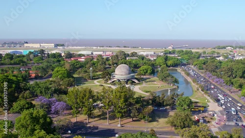 Aerial dolly in view of  Galileo Galilei planetarium building situated in a park with a pond in Buenos Aires, Argentina. Day time  photo
