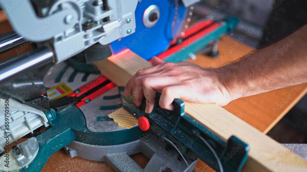 cutting wood with a miter saw. construction tool at work