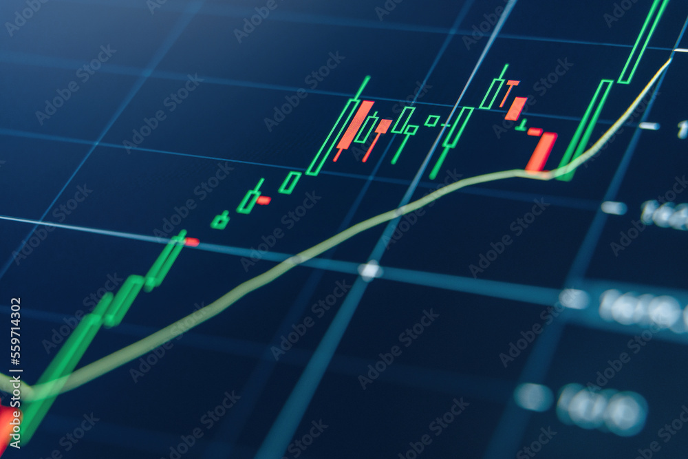 Closeup of stock market volatility of crypto trading with technical price graph and indicator, red and green candlesticks on blue display background Closeup of stock market volatility of crypto trading with technical price graph and indicator, red and green candlesticks on blue display background