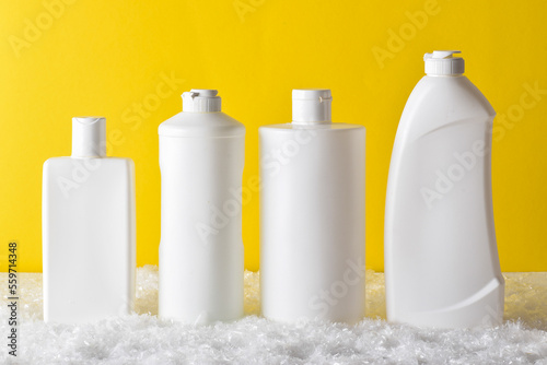 Wallpaper Mural Plastic white bottles stand on a yellow background. Cleaning and disinfection of premises. Torontodigital.ca