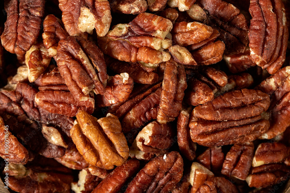Pecan on dark background. Healthy fat. Heap shelled Pecans nut. Close up. Keto diet. Studio shoot. Top view Pecan on dark background. Healthy fat. Heap shelled Pecans nut. Close up. Keto diet. Studio shoot. Top view