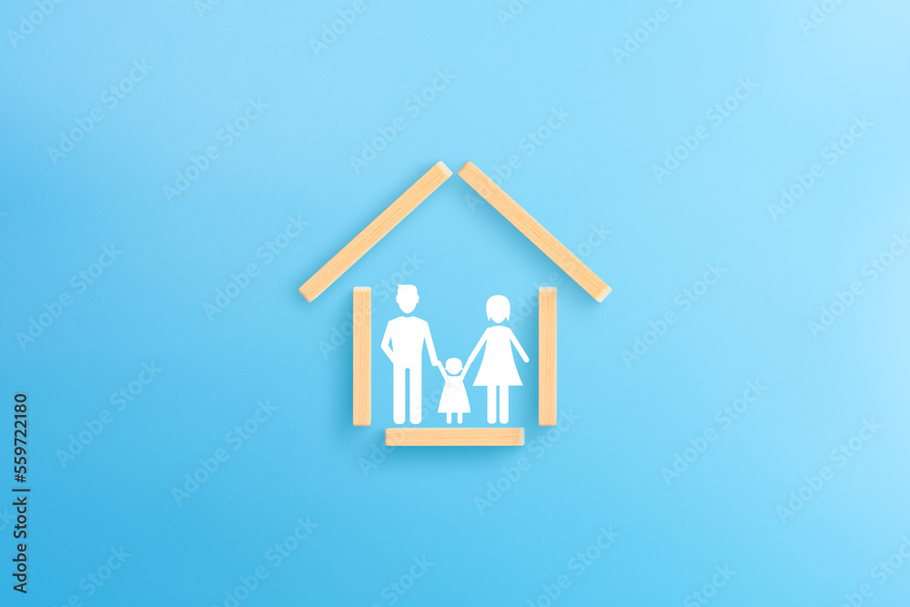 Wooden house frame on blue background, Family care, insurance, protection concept Wooden house frame on blue background, Family care, insurance, protection concept