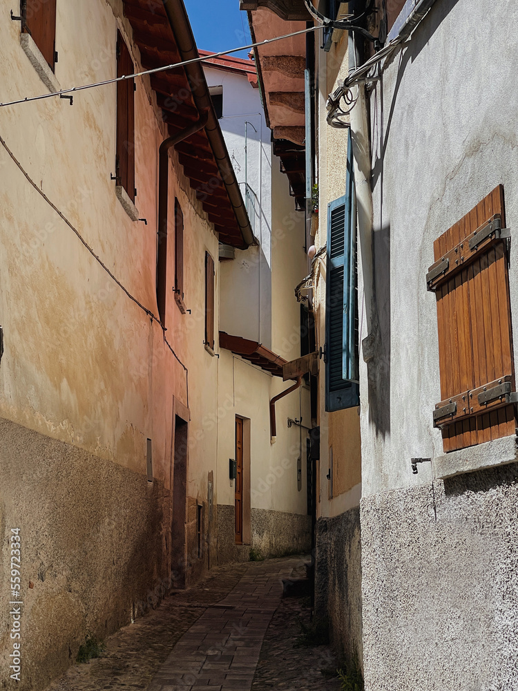 Obraz premium Old historic architecture in Italy. Traditional European old town buildings. Aesthetic summer travel concept. Sunlight shadows