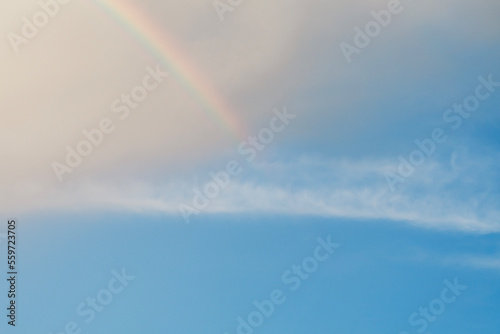 clear sky rainbow background fluffy white clouds © Pintira