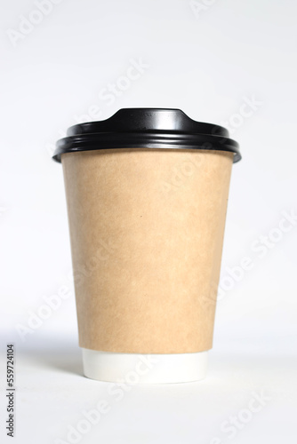 a disposable cup with a dark lid on a light background