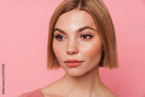 Young blonde woman with short hair looking aside