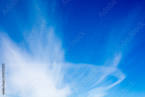 Blue sky with fluffy clouds background