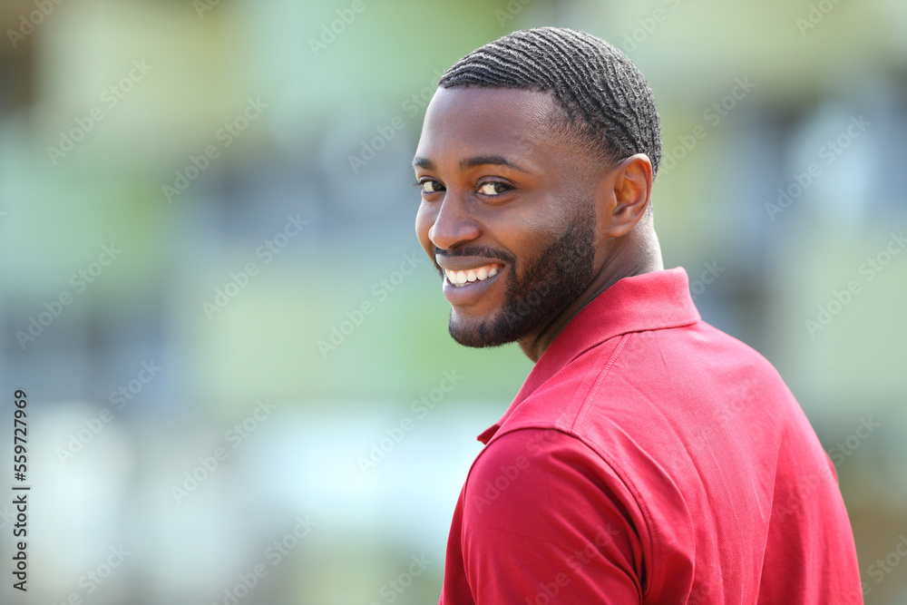 Happy black man with white smile looks at camera Happy black man with white smile looks at camera