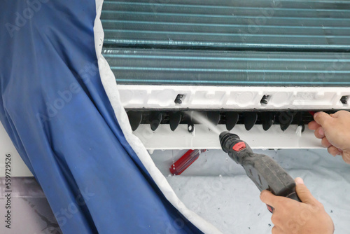 air conditioning cleaning service with water spray photo