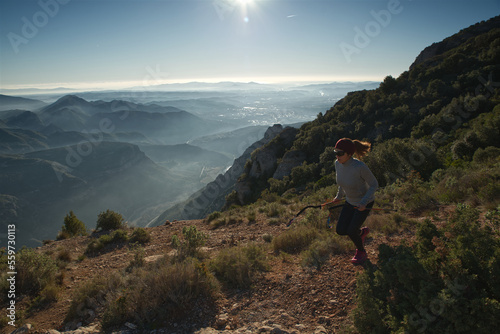 Woman runs through the mountains of Montserrat in Catalonia, Spain.