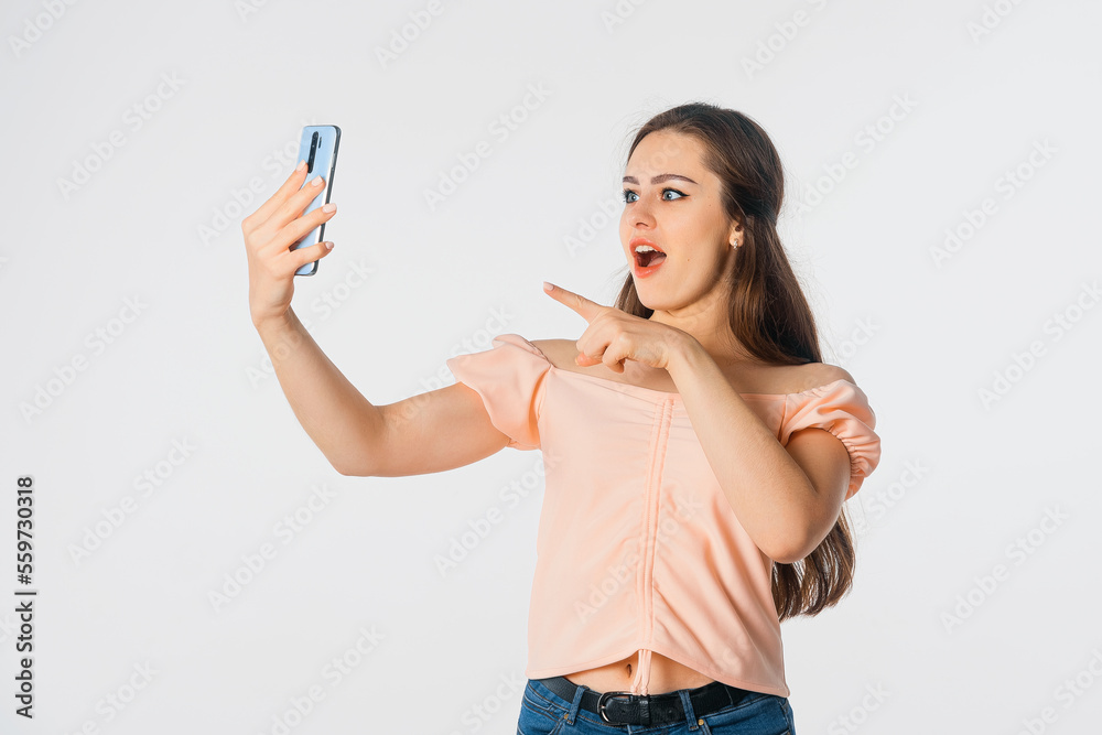 Enthusiastic young woman holding smartphone using mobile phone app for video call, laughing while watching funny video, feeling excited winning online lottery bid on cellphone Enthusiastic young woman holding smartphone using mobile phone app for video call, laughing while watching funny video, feeling excited winning online lottery bid on cellphone