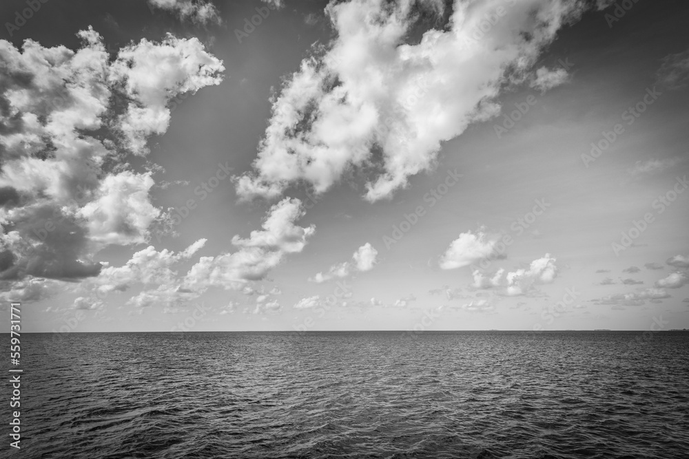 Dramatic sea view, monochrome  seascape, white clouds dark deep ocean bay. Coastline in black and white, abstract sky. Exotic Mediterranean tropical sea view. Dream motivation and inspire Earth nature
