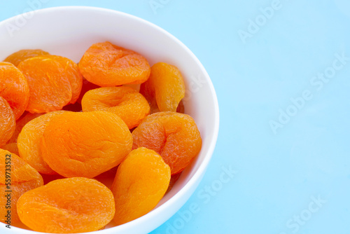 Dried apricots on blue background.