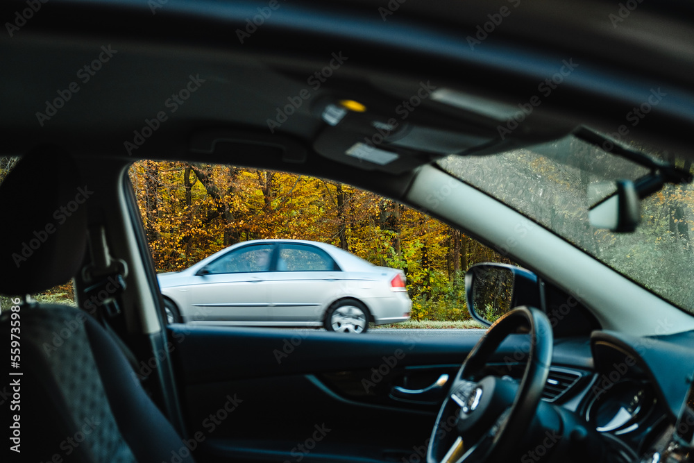 view through the car window to the road. the car drives along the autumn road view through the car window to the road. the car drives along the autumn road