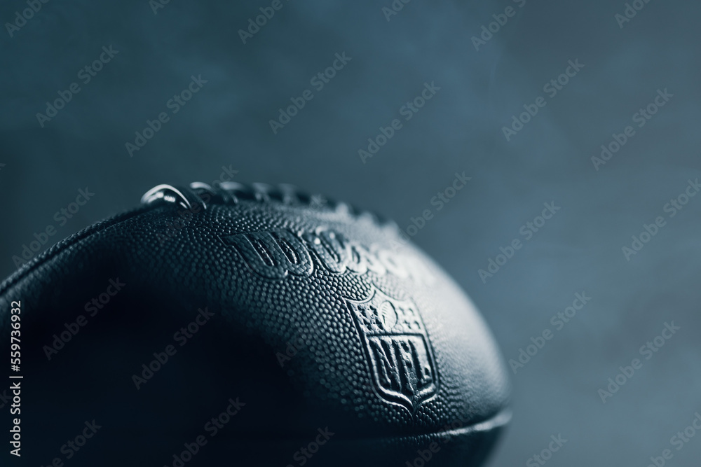 A football in epic light situation with the logo of the official brand "NFL  National Football League" as symbol for the upcoming LVII Super Bowl foto  de Stock | Adobe Stock