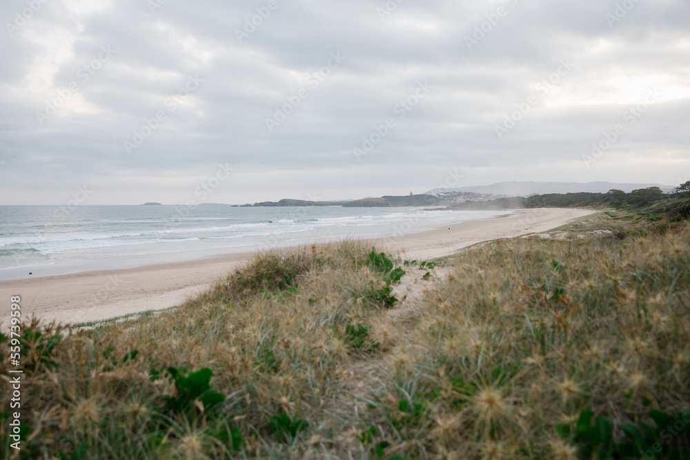 Horizontal shot of shoreline with beach waves at sunset Horizontal shot of shoreline with beach waves at sunset