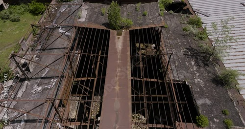 Fly Over Rusted Roofs Of Abandoned Industrial Site In Khashuri, Georgia. Aerial Drone Shot photo