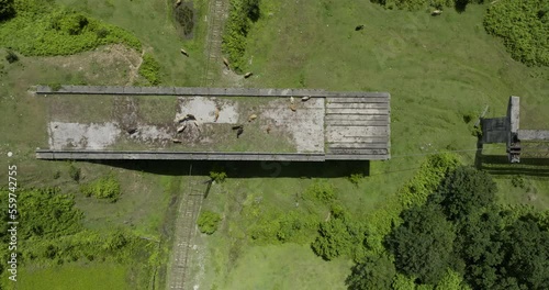 Aerial shot of desolated, unfinished bridge doomed to be destroyed by time. photo