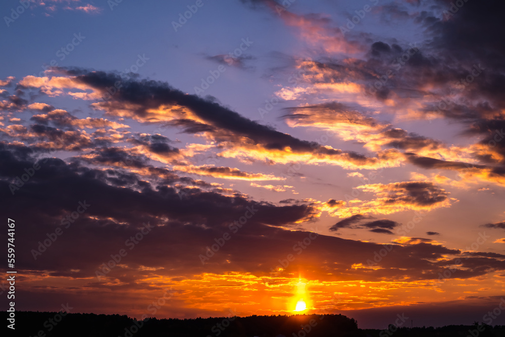 Blue violet red sunset sky background with evening curly rolling clouds may use for sky replacement Blue violet red sunset sky background with evening curly rolling clouds may use for sky replacement