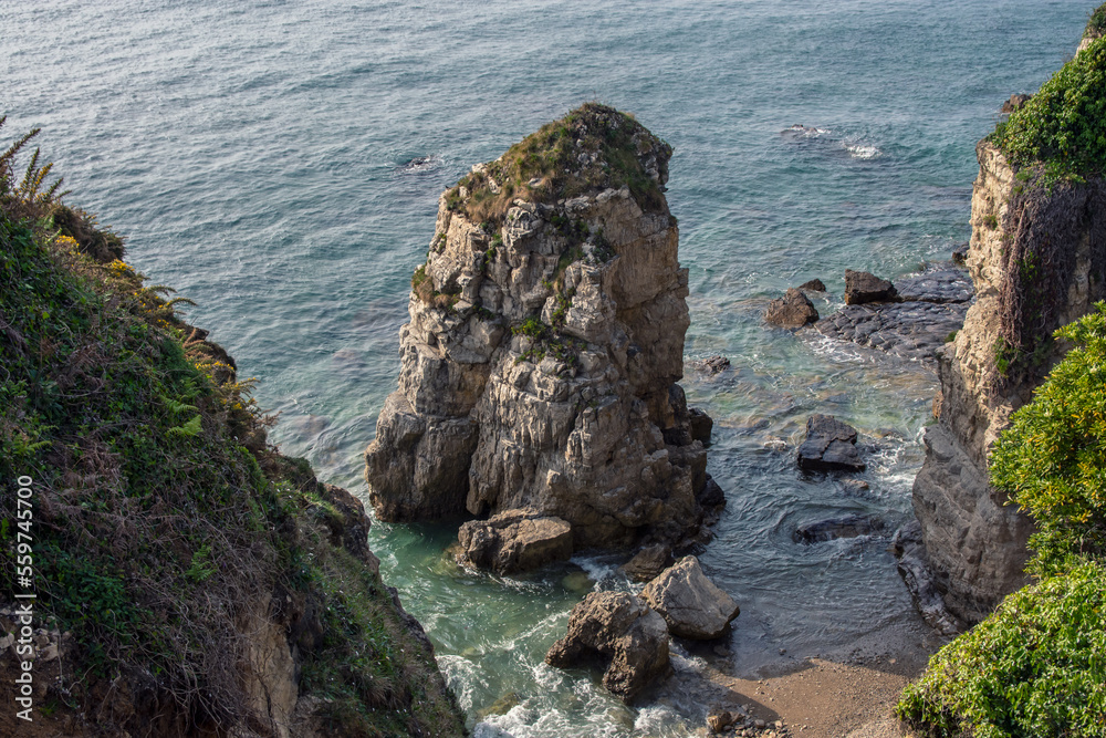 Idyllic beach landscape with rocks in Gijón