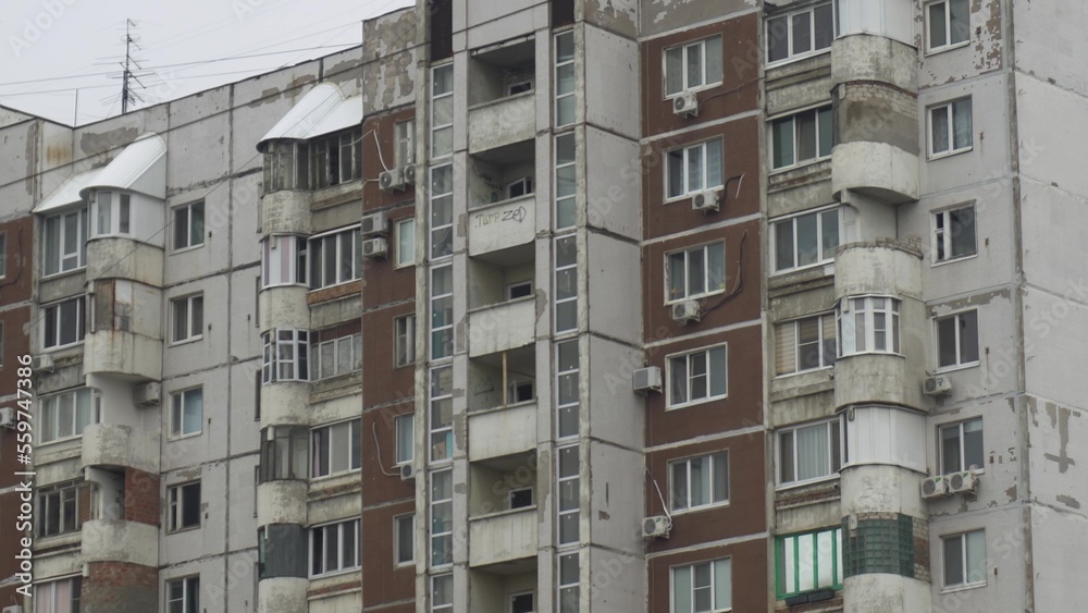 Old concrete apartment building of the ussr close-up. Soviet panel house.