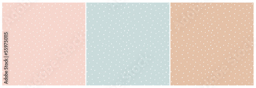 Abstract Hand Drawn Childish Vector Pattern Set. White Brush Spots and Dots on Light Pink, Pastel Blue and Beige Background. Modern Geometric Seamless Pattern. Irregular Freehand Print.	
