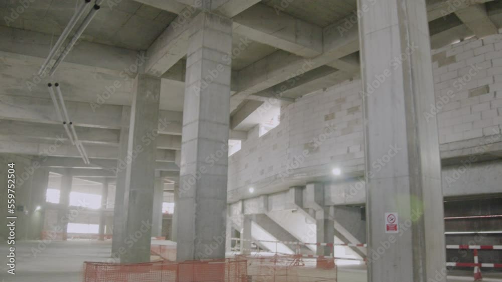 Concrete carcass and brick walls in sports stadium building hall. Inner view of athletic arena construction site Concrete carcass and brick walls in sports stadium building hall. Inner view of athletic arena construction site