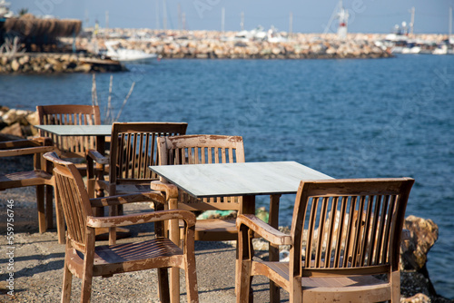 cafe on the beach with old empty tables  © Yelena