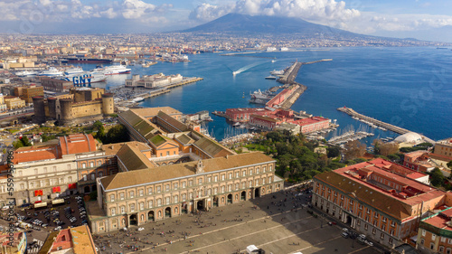 Aerial view of the Royal Palace of Naples, Italy. It was a royal seat for the kings of Naples and the Bourbons.It's located in Plebiscito square.In background the Maschio Angioino and Vesuvius volcano photo