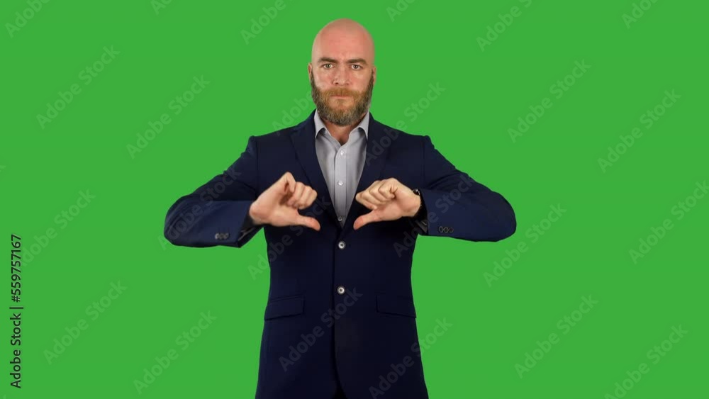 A businessman giving a thumbs down gesture in disagreement and unapproval A businessman giving a thumbs down gesture in disagreement and unapproval