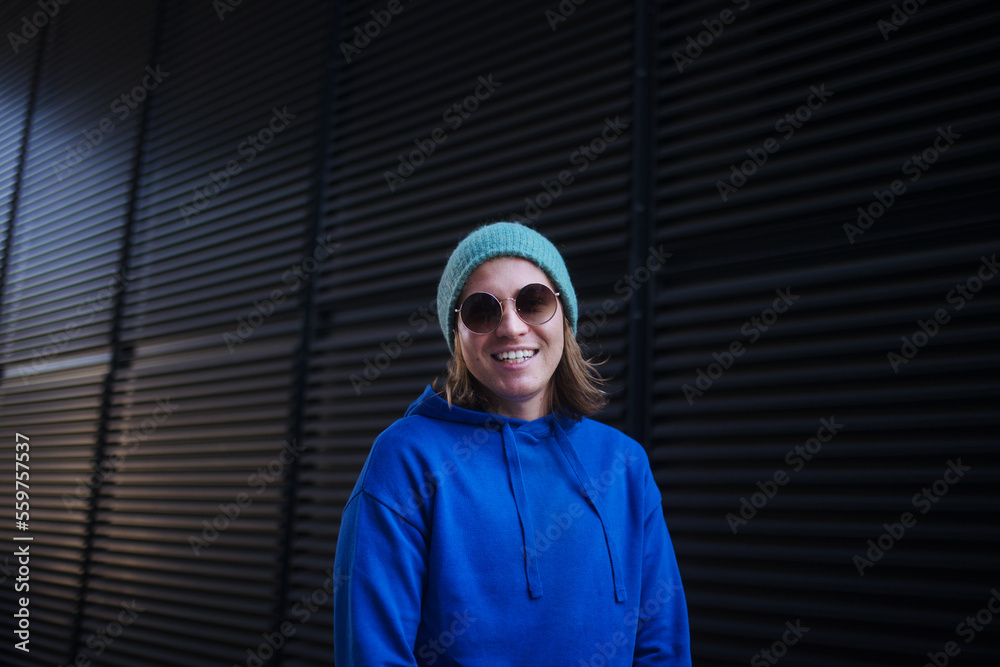 Portrait of young man with cap and sunglasses outdoor in city. Youth culture. Portrait of young man with cap and sunglasses outdoor in city. Youth culture.