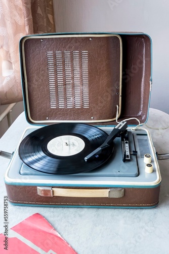 An old compact vinyl record player in a suitcase