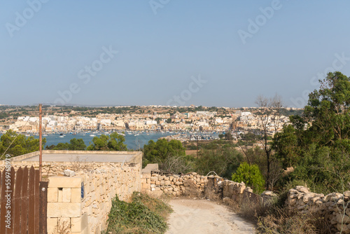 Malta, Marsaxlokk, June 2019. View of the city from a country road.