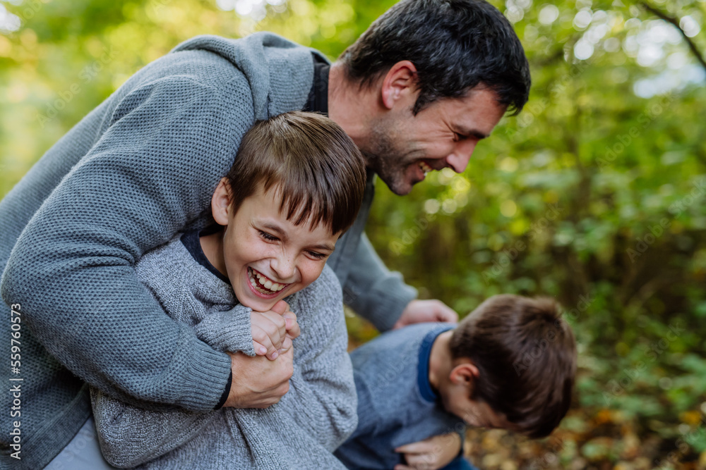 Father having fun with his sons in forest. Father having fun with his sons in forest.