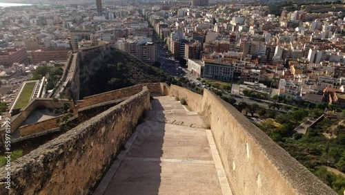 Walking down on stone wall towards Alicante centre, Santa Barbara Castle at Serra Grossa San Julian Mountain in Alicante, Spain, ALICANTE, SPAIN - NOVEMBER 19