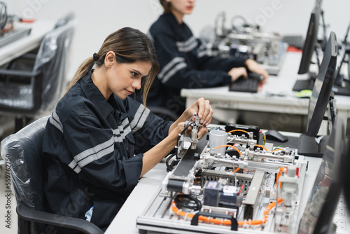 Fotografering Engineer caucasian woman learning repair electric board in class