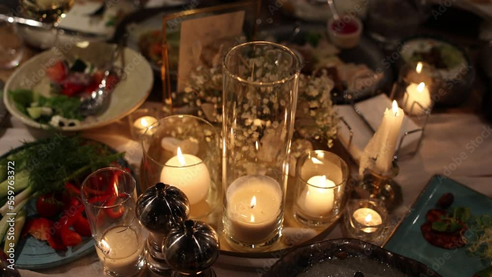 banquet table in a restaurant with candles in the evening at a wedding