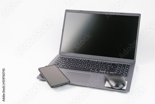 Laptop with mouse and mobile on white background