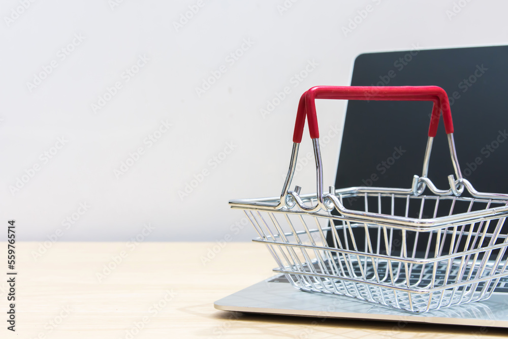 Online shop on web site supermarket cart on computer laptop. 
Service for delivery app online shopping concept.  copy space