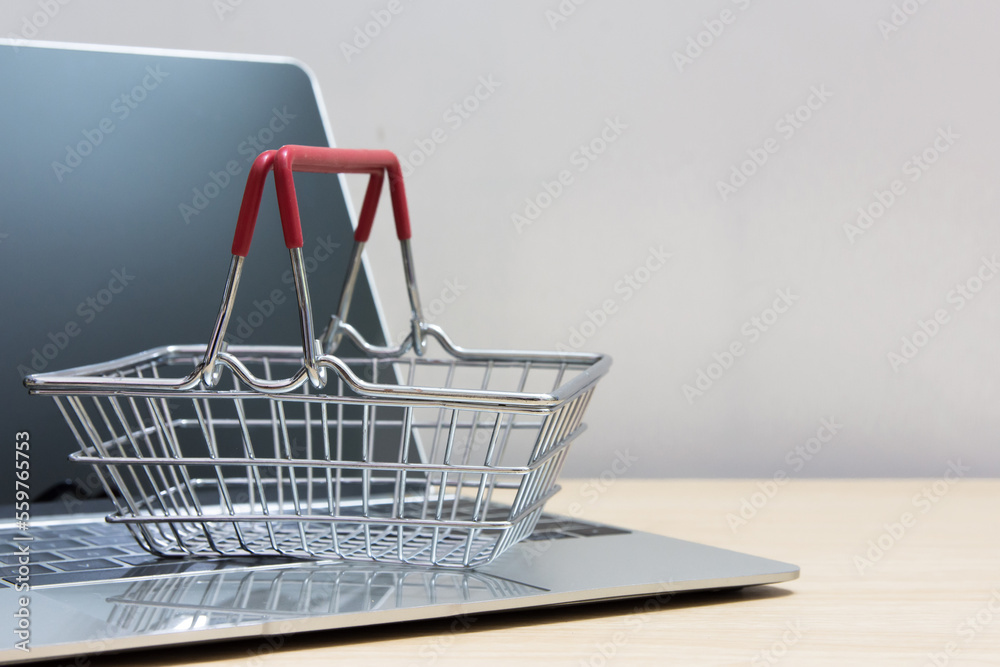 Online shop on web site supermarket cart on computer laptop. 
Service for delivery app online shopping concept.  copy space