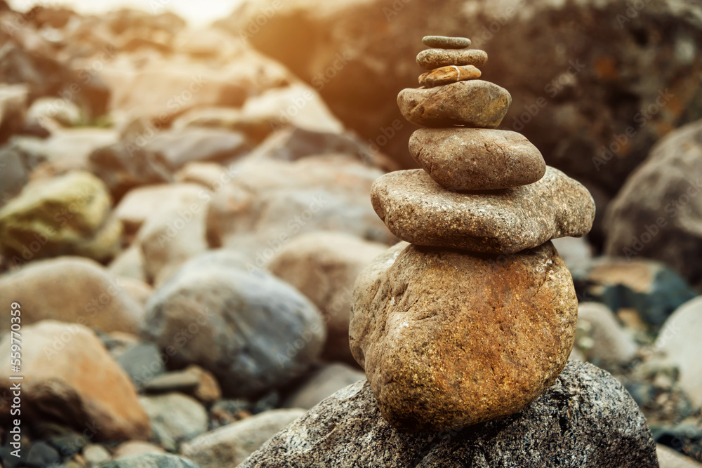 Pyramid of stones in the mountains. Cairn making by tourists. Abstract rock construction. Pyramid of stones in the mountains. Cairn making by tourists. Abstract rock construction.