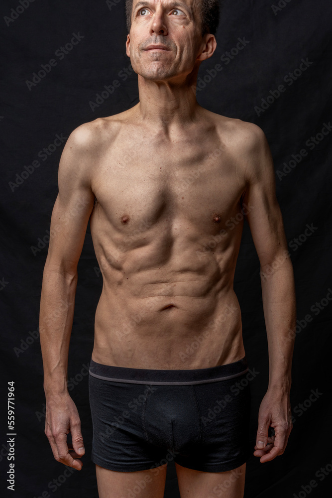Naklejka premium Paris, France - 01 09 2023: still life. Studio shot of a mature man posing shirtless
