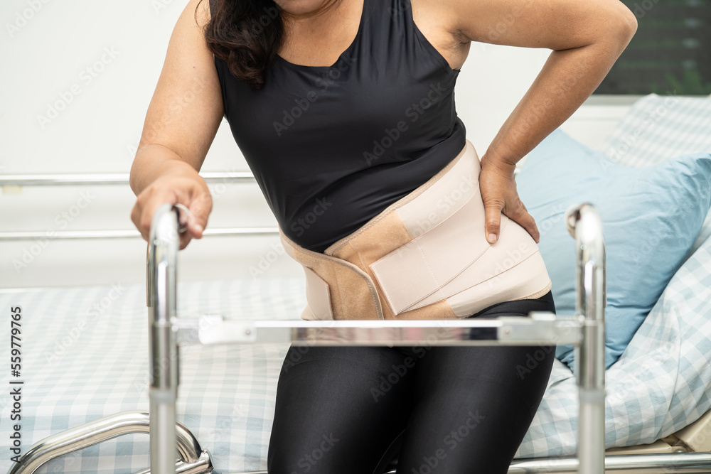 Asian lady patient pain her back, waist and orthopedic lumbar with walker. Asian lady patient pain her back, waist and orthopedic lumbar with walker.