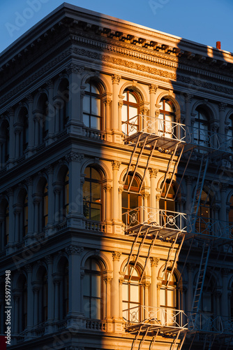 Photography Last sun rays on Soho loft buildingwith facade ornamentation and fire escape