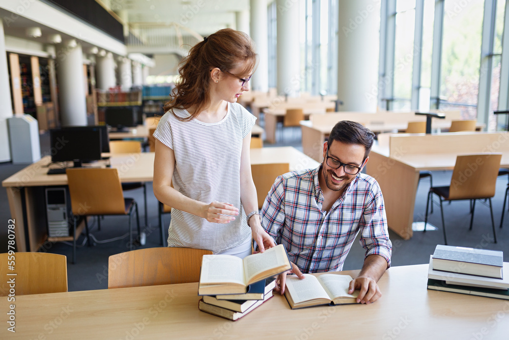 Students studying in library. Young success people are spending time together and learning together. Students studying in library. Young success people are spending time together and learning together.